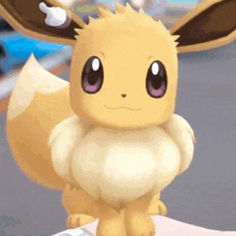 a close up of a yellow eevee with purple eyes sitting on a person 's lap .
