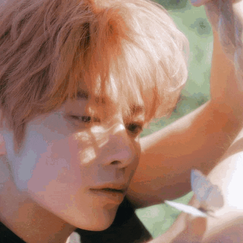 a close up of a man 's face with a butterfly in the background