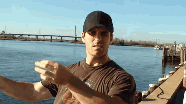 a man wearing a hat and a t-shirt that says ' navy ' on it