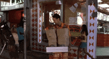 a man stands in front of a sausage up pop stand