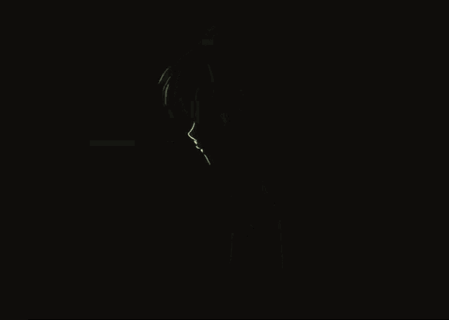 a man in a suit and tie is in the dark