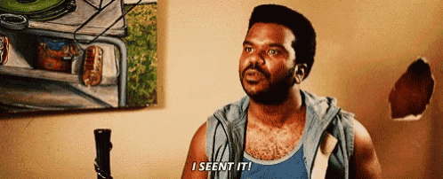 a man is standing in front of a painting and says i seen it