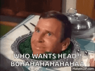 a man is sitting on a table with his head in a tray .