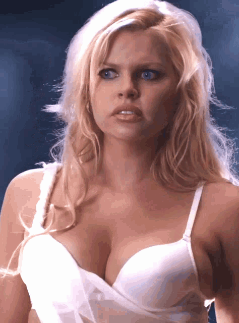 a woman in a white bra with a very large breast