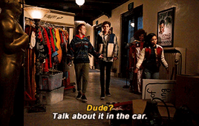 a group of people standing in a hallway with the words dude talk about it in the car on the bottom