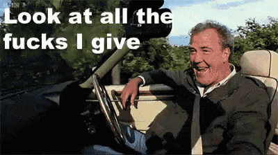 a man is sitting in a car with the words look at all the fucks i give behind him