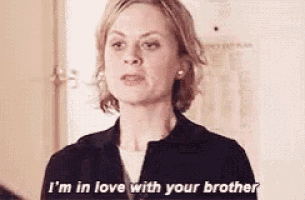 a woman is saying `` i 'm in love with your brother '' while standing in front of a door .