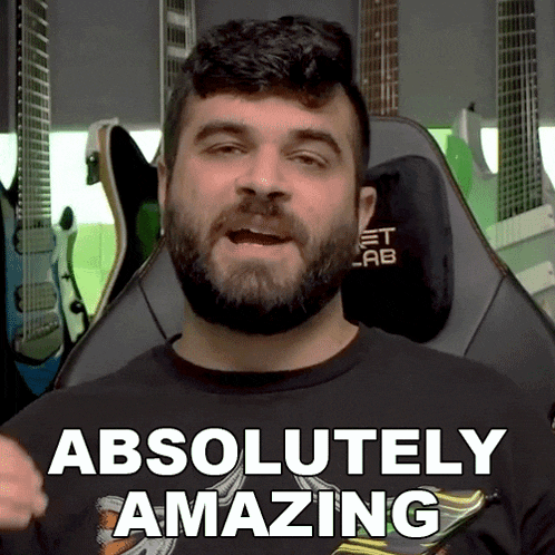 a man with a beard is wearing a shirt that says " absolutely amazing "