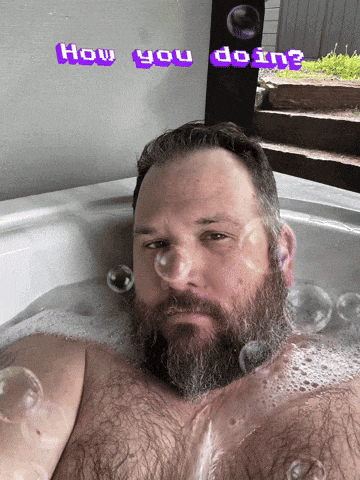 a man with a beard is taking a bath with the words how you doin written above him
