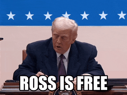 a man in a suit and tie is sitting at a desk with the words " ross is free " written on it
