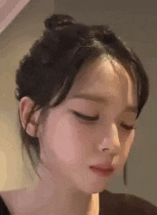 a close up of a woman with her eyes closed .