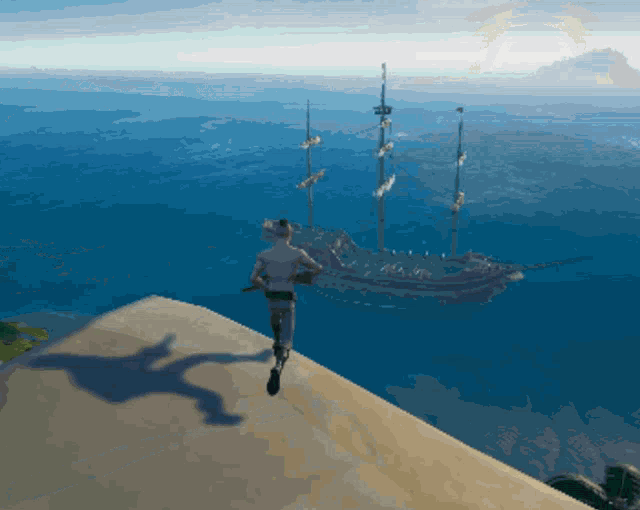 a man is standing on a cliff overlooking the ocean with a large ship in the background