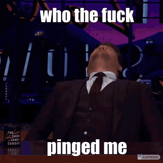 a man in a suit and tie is making a funny face and saying who the fuck pinged me