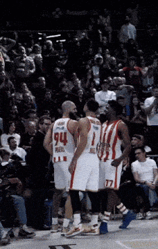 a group of basketball players with one wearing the number 94