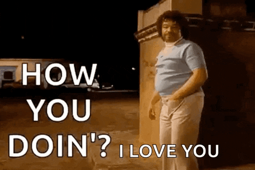 a man is standing in front of a building with the words `` how you doin ? i love you '' written on it .