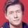 a blurry picture of a young man 's face with a red background .