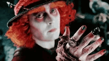 the mad hatter from alice in wonderland is wearing a hat and holding a clock .