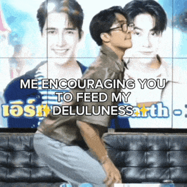 a man kissing another man on the cheek in front of a wall that says me encouraging you to feed my deluousness