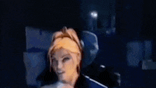 a close up of a person 's face in a dark room with a blurry background .