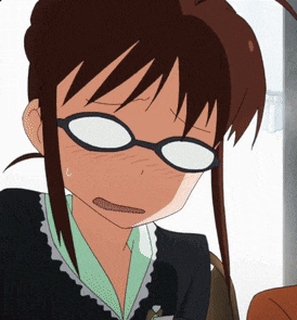 a close up of a girl wearing glasses with a surprised look on her face
