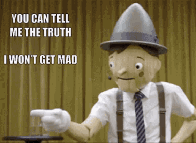 a wooden puppet with a hat and suspenders is pointing at someone