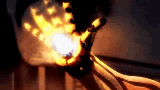 a close up of a person 's hand holding a fireball .