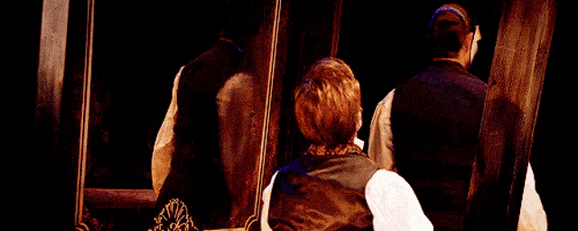 a man with a mask on his face looks at his reflection in a mirror