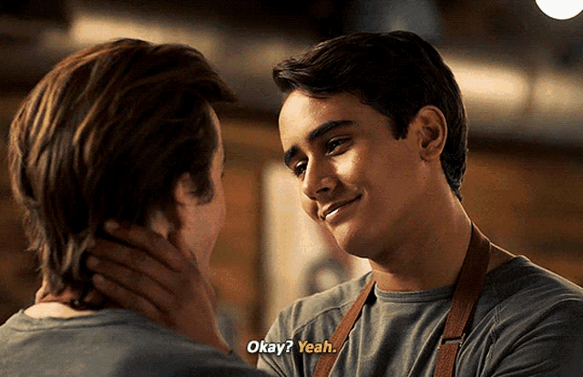 two men are looking at each other and one of them is saying okay yeah