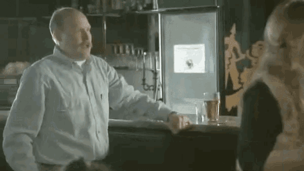 a man talking to a woman at a bar