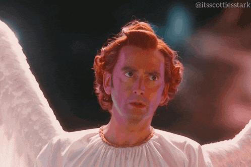 a man with red hair and white wings has the hashtag itsscottiesstark at the bottom
