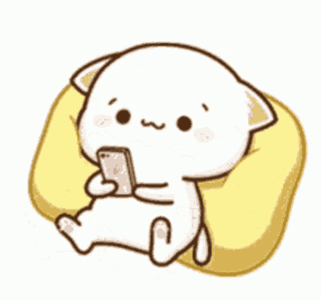 a cute cartoon cat is sitting on a pillow holding a cell phone .