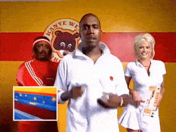 a man in a white shirt is standing in front of a yellow wall that says kanye west