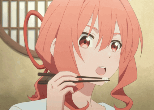 a woman with red hair is holding chopsticks in her mouth