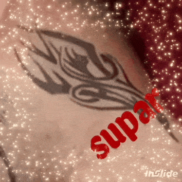a close up of a tattoo with the word supa in red