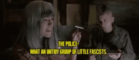 a woman smoking a cigarette with the words the police what an untidy group of little fascists behind her