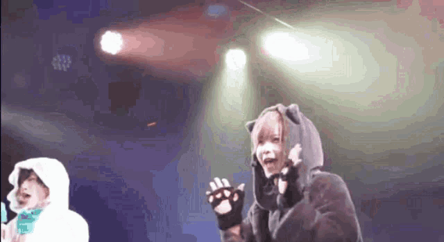 a person wearing a cat ear hoodie and paw gloves
