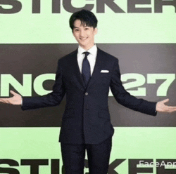 a man in a suit and tie is standing in front of a sign that says sticker