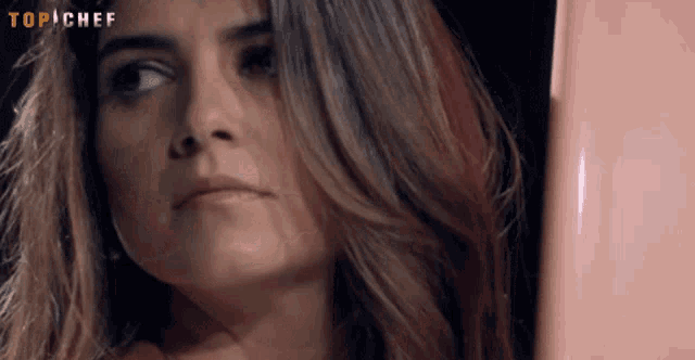 a close up of a woman 's face with the words top chef visible