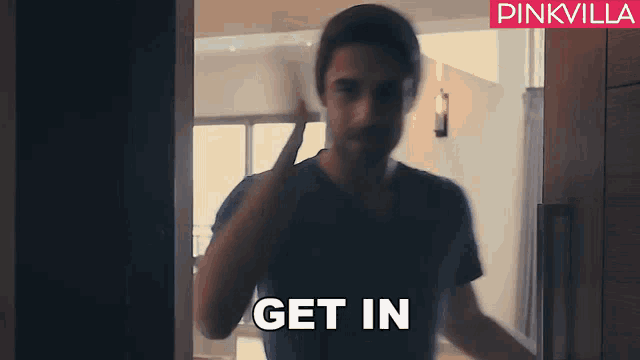 a man is standing in a doorway with the words get in written on the bottom