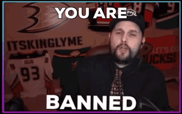 a man wearing a black hat and tie says you are banned