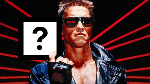 a man wearing sunglasses holds up a sign with a question mark