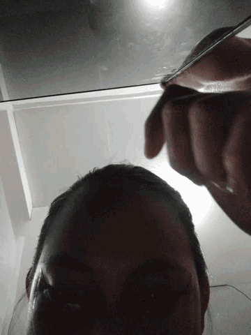 a close up of a person 's face with a reflection in the mirror