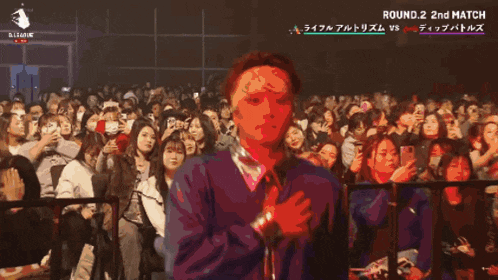 a man stands in front of a crowd with umi dip battles written on the bottom