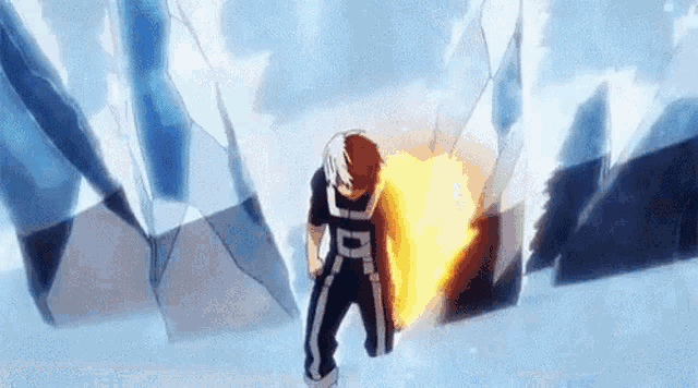 a person is standing in the snow holding a fireball in their hand .