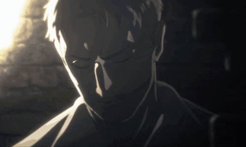a close up of a man 's face with his eyes closed in a dark room