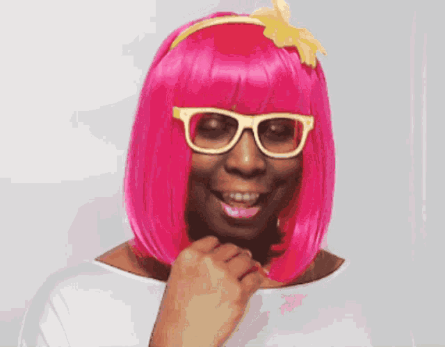a woman wearing a pink wig and glasses