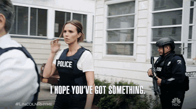 a woman wearing a police vest says i hope you 've got something
