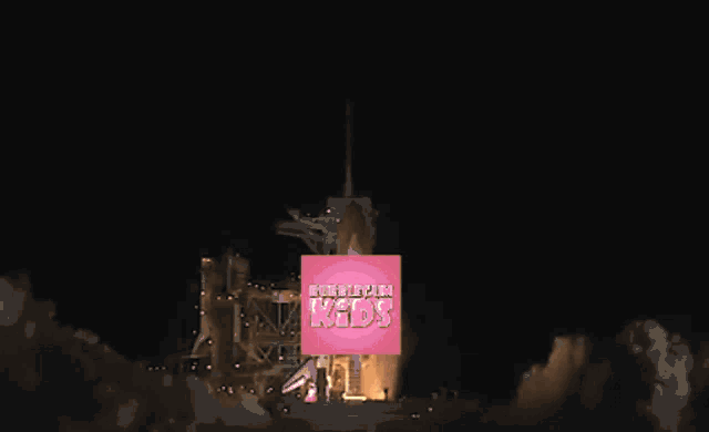 a picture of a rocket being launched with a pink box that says birthday kids