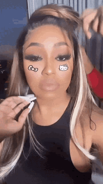 a woman with hello kitty tattoos on her face
