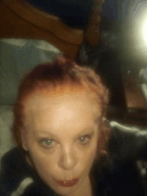 a close up of a woman 's face with a blurry background